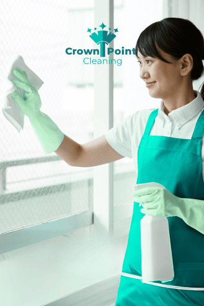Lady working for Crown Point Cleaners, cleaning apartment window in Concord NC.