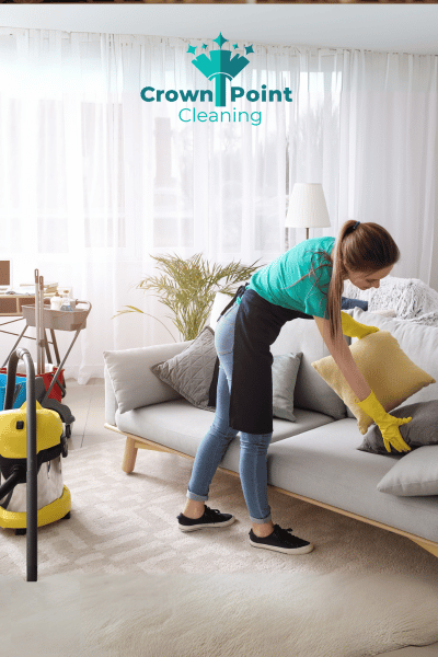 Lady working for fixing pillows, while on AirBnb Turnover cleaning job in Huntersville NC.