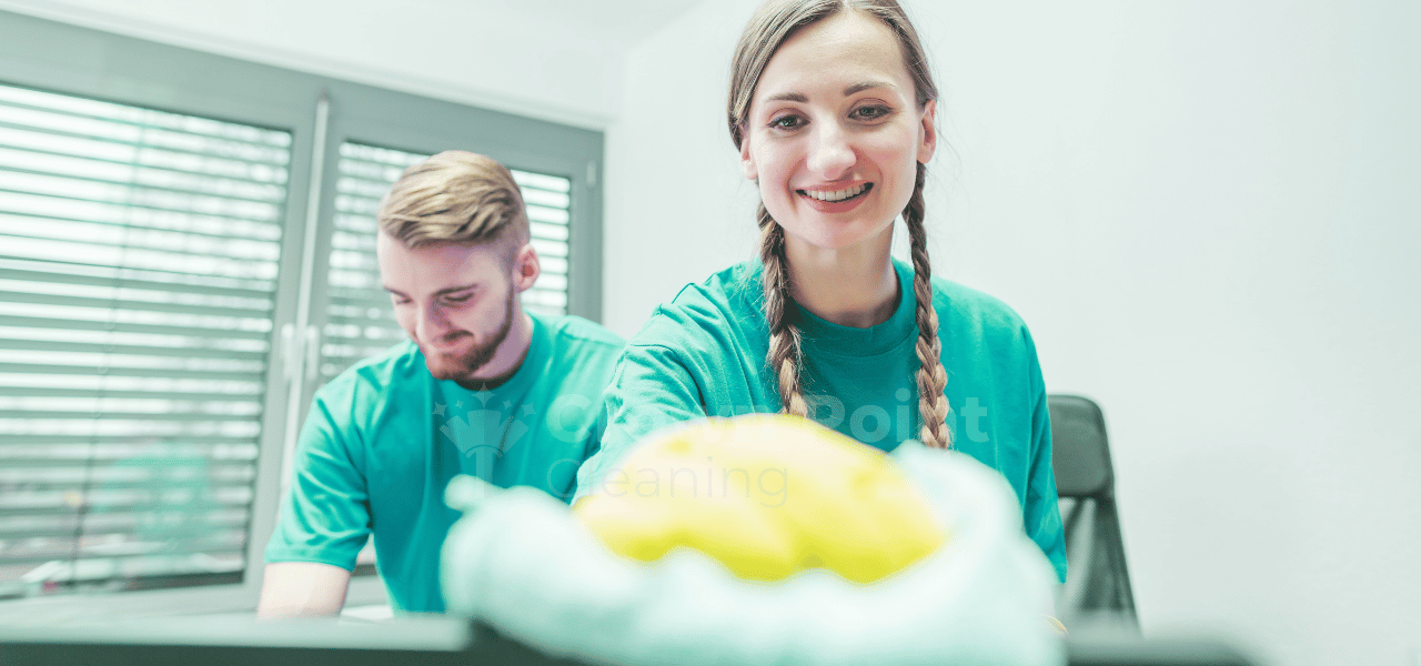 Cleaner wiping down surface on a commercial job for Crown Point Cleaning, the best janitorial company in Charlotte, NC.